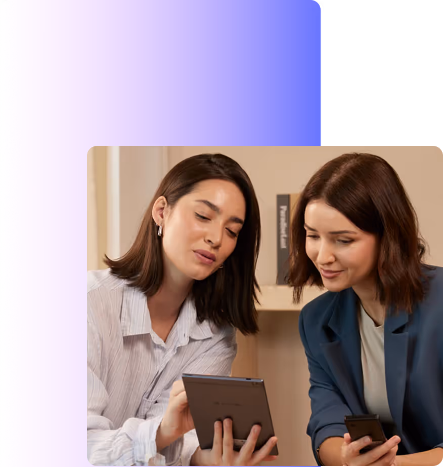Two people reviewing notes on the device