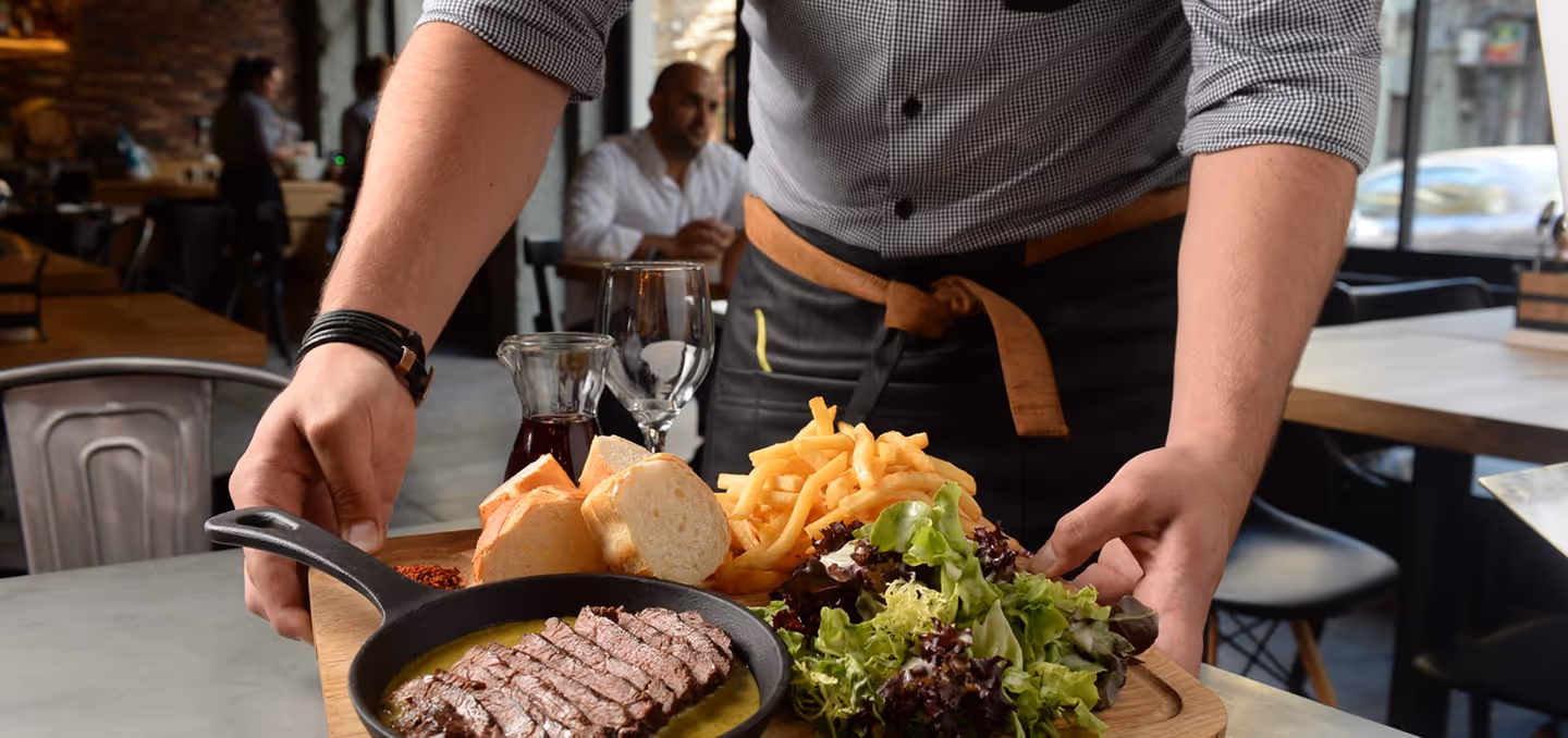Server presenting a Swiss Butter dish